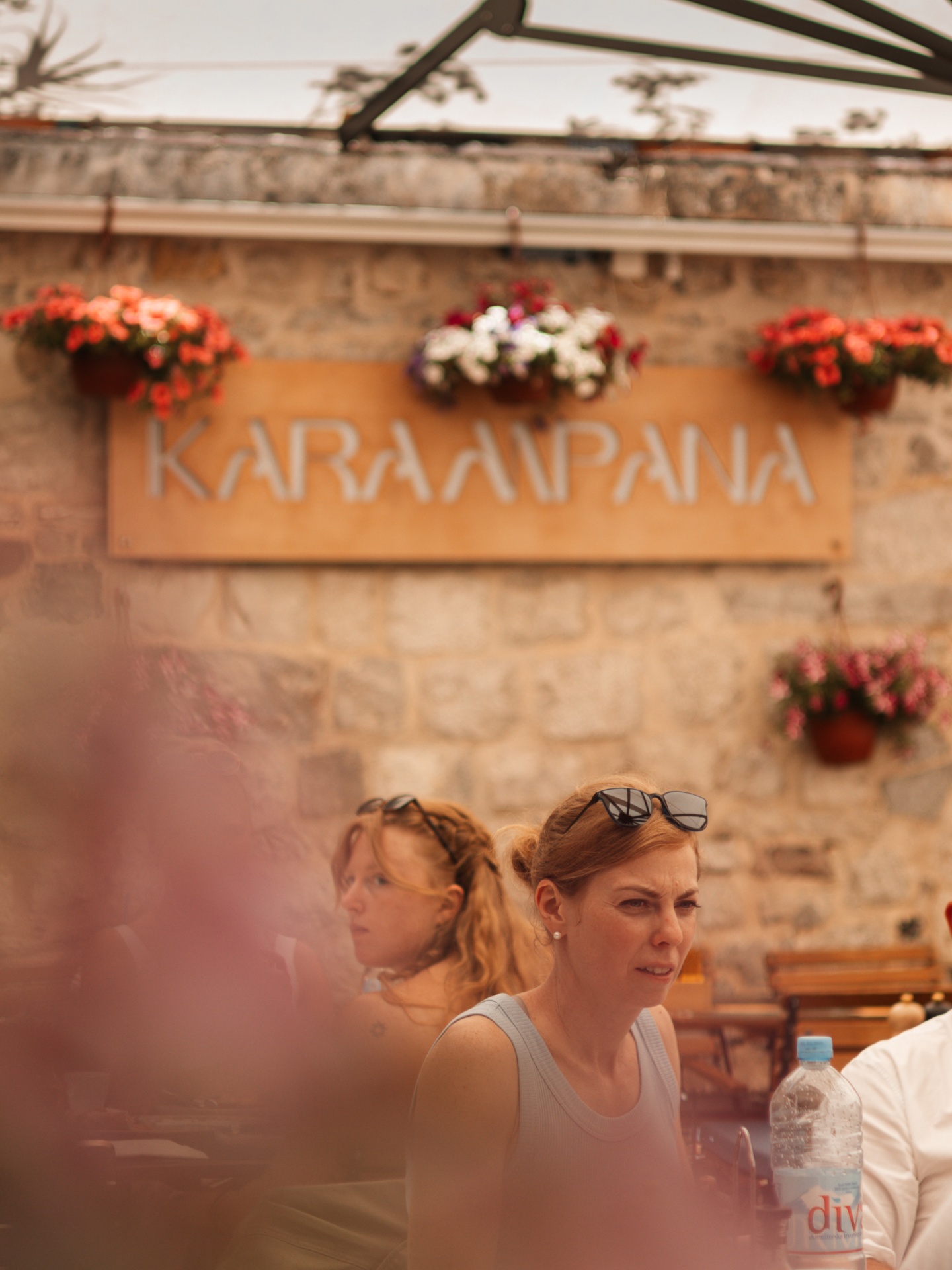 Karampana sign framed by hanging flowers